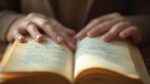 Gros plan sur les mains tenant avec soin un livre ouvert